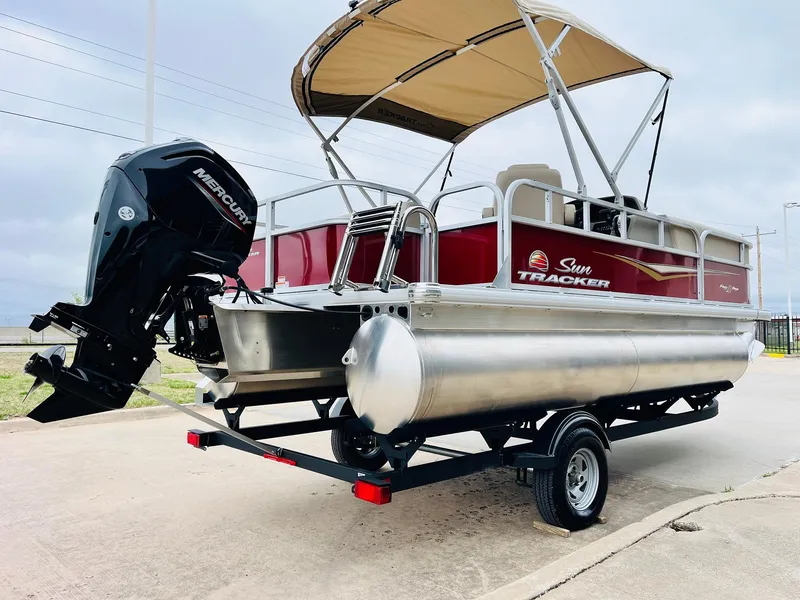 Slide: The Image of 2025 Sun Tracker Party Barge 18 DLX pontoon boat with Mercury engine on trailer. - 7