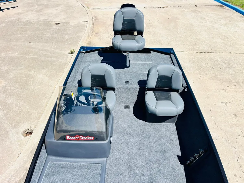 Slide: The Image of 2025 Tracker Bass Tracker Classic XL boat with four gray seats on a concrete surface. - 12