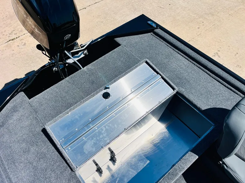 Slide: The Image of 2025 Tracker Bass Tracker Classic XL boat with open storage compartment, showing interior details. - 21