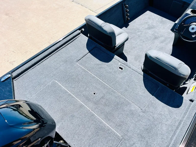 Slide: The Image of 2025 Tracker Bass Tracker Classic XL boat interior with gray carpet and two seats. - 22