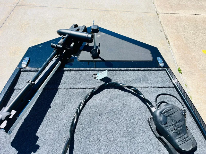 Slide: The Image of 2025 Tracker Bass Tracker Classic XL boat deck with trolling motor and foot pedal. - 8