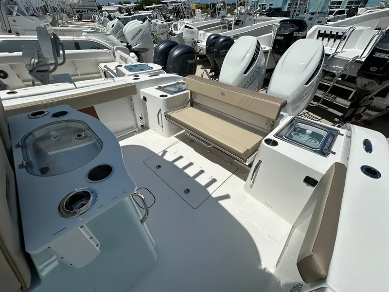 Slide: The Image of 2025 Sea Pro 292 Offshore boat interior with seating, storage, and dual outboard motors. - 11