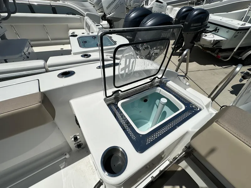Slide: The Image of 2025 Sea Pro 292 Offshore boat with open livewell and dual outboard motors. - 13
