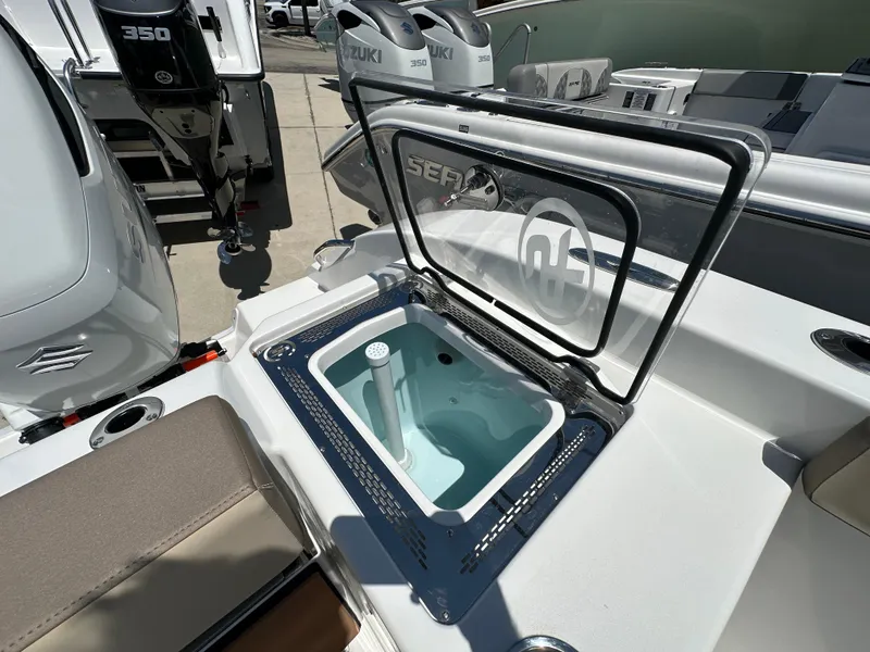 Slide: The Image of 2025 Sea Pro 292 Offshore boat with open livewell, Suzuki 350 outboard engines in background. - 14