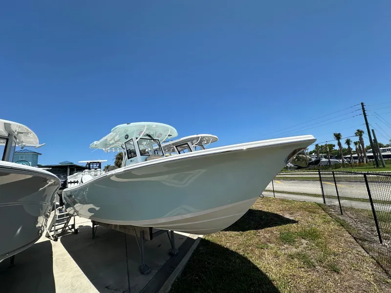 Slide: The Image of 2025 Sea Pro 292 Offshore boat displayed outdoors under clear blue sky. - 2