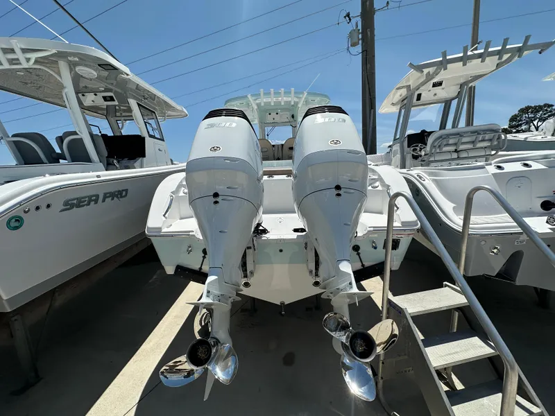 Slide: The Image of 2025 Sea Pro 292 Offshore boat with dual outboard engines, docked alongside similar vessels. - 3