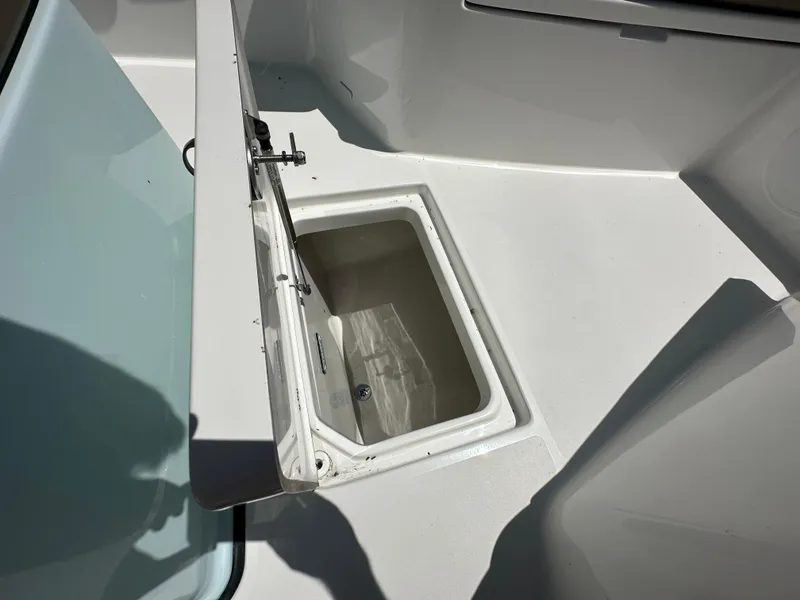 Slide: The Image of 2025 Sea Pro 292 Offshore boat storage compartment with open lid, showcasing interior space. - 8