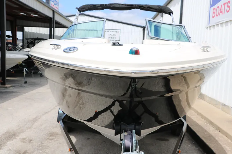 Slide: The Image of 2004 Sea Ray 220 Select boat on trailer, front view, parked at dealership. - 11
