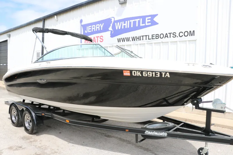 Slide: The Image of 2004 Sea Ray 220 Select boat on trailer, parked outside Jerry Whittle Boats dealership. - 13