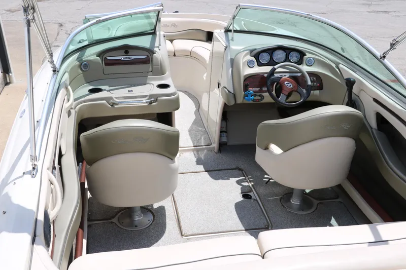 Slide: The Image of Interior of a 2004 Sea Ray 220 Select boat, featuring seating and dashboard controls. - 16
