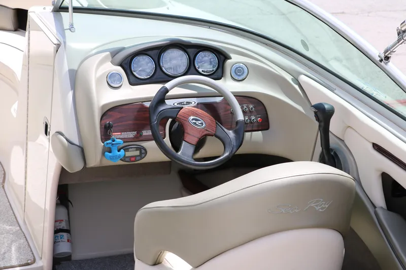 Slide: The Image of 2004 Sea Ray 220 Select boat dashboard with steering wheel and instrument panel. - 17