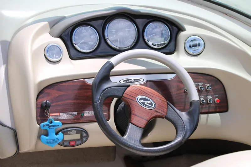 Slide: The Image of Dashboard of a 2004 Sea Ray 220 Select boat with steering wheel and gauges. - 18