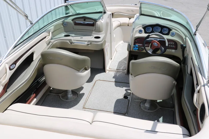 Slide: The Image of 2004 Sea Ray 220 Select boat interior with beige seating and dashboard. - 19