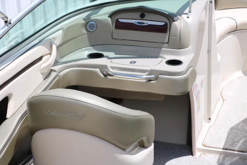 Slide: The Image of 2004 Sea Ray 220 Select boat interior with beige seating and dashboard. - 20