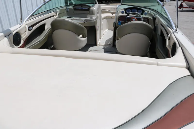 Slide: The Image of 2004 Sea Ray 220 Select boat interior with beige seating and dashboard. - 21