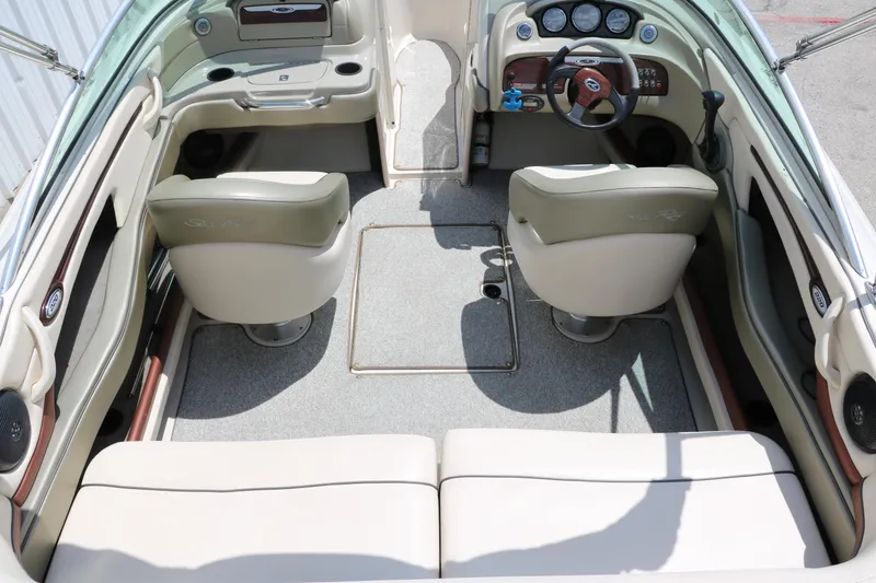 Slide: The Image of Interior of 2004 Sea Ray 220 Select boat with beige seating and dashboard. - 22