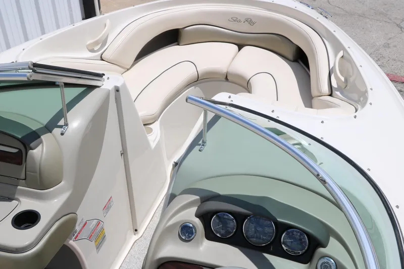Slide: The Image of 2004 Sea Ray 220 Select boat interior with beige seating and dashboard controls. - 23