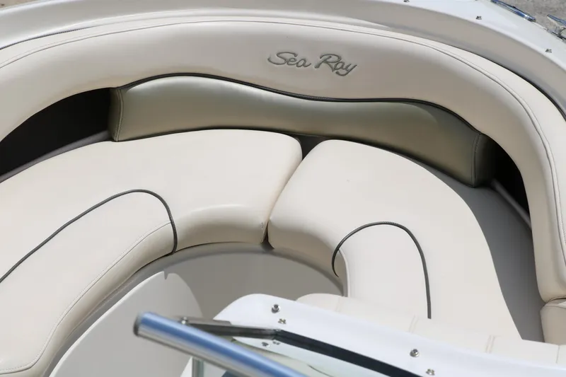 Slide: The Image of 2004 Sea Ray 220 Select boat interior with beige seating and logo. - 24