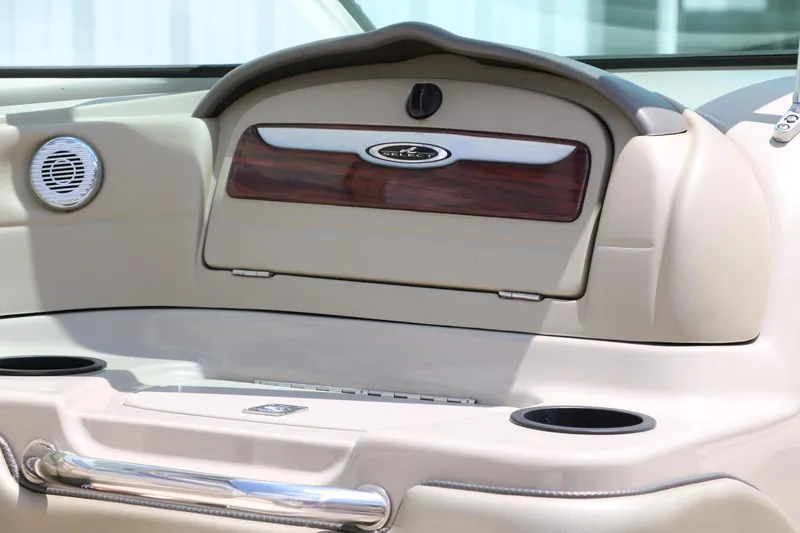 Slide: The Image of 2004 Sea Ray 220 Select dashboard with wood accents and cup holders. - 27