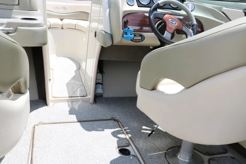 Slide: The Image of Interior of a 2004 Sea Ray 220 Select boat, featuring steering wheel and seating. - 28