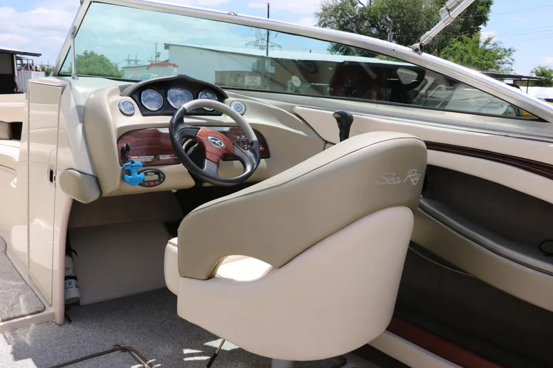 Slide: The Image of 2004 Sea Ray 220 Select boat interior with steering wheel and dashboard. - 29