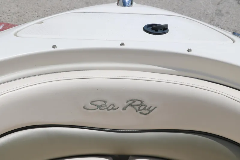 Slide: The Image of 2004 Sea Ray 220 Select boat interior with logo on white upholstery. - 32