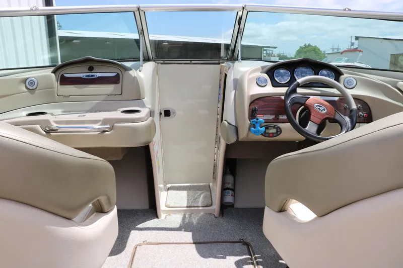 Slide: The Image of Interior view of 2004 Sea Ray 220 Select boat cockpit with steering wheel and dashboard. - 39