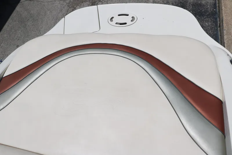 Slide: The Image of 2004 Sea Ray 220 Select boat seat with white, brown, and silver upholstery design. - 40