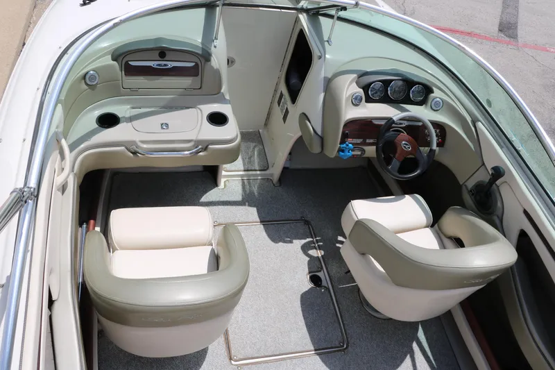 Slide: The Image of 2004 Sea Ray 220 Select boat interior with beige seating and dashboard controls. - 41