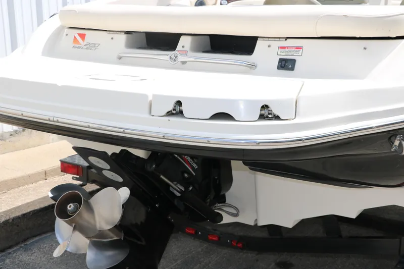 Slide: The Image of Rear view of 2004 Sea Ray 220 Select boat with visible propeller and stern details. - 5