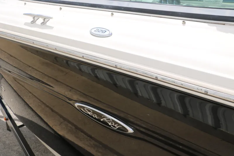 Slide: The Image of 2004 Sea Ray 220 Select boat side view with logo and model details. - 9