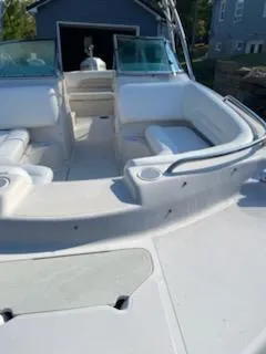 Slide: The Image of 2002 Hurricane 217 Sundeck boat interior with white seating and open deck. - 10