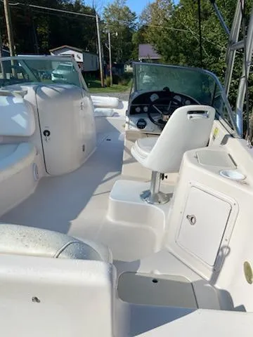 Slide: The Image of 2002 Hurricane 217 Sundeck boat interior with steering wheel and seating. - 4