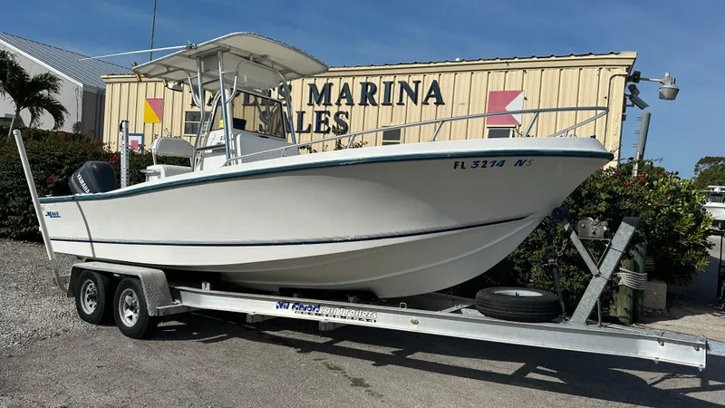 Slide: The Image of 1998 Mako 232 Center Console boat on trailer at marina sales lot. - 1