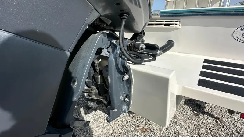 Slide: The Image of 1998 Mako 232 Center Console boat engine detail, showing motor and transom components. - 11