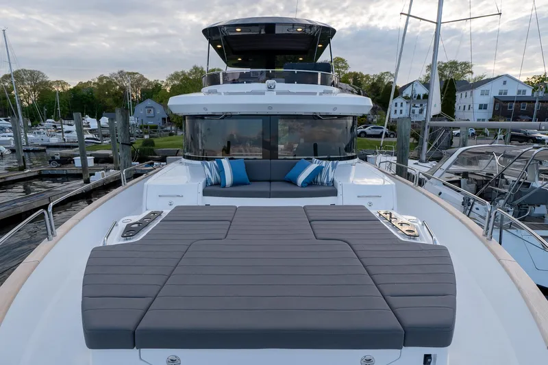 Slide: The Image of 2024 Sirena 58 Flybridge yacht with spacious deck and luxurious seating at marina. - 14
