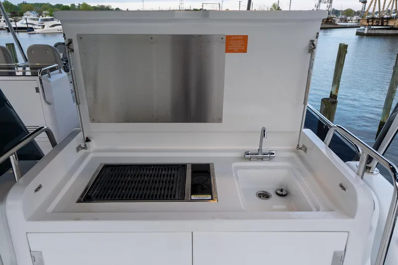 Slide: The Image of Outdoor kitchen on 2024 Sirena 58 Flybridge yacht with grill and sink. - 21