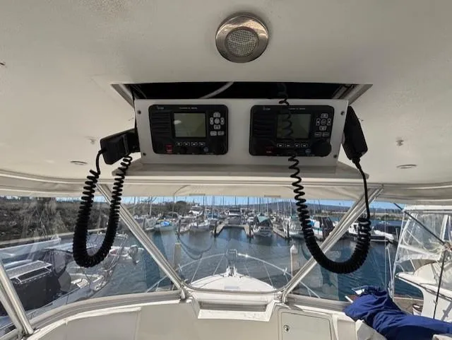 Slide: The Image of 2007 Jersey Cape 44 CNV boat cockpit with dual radios, overlooking marina. - 10