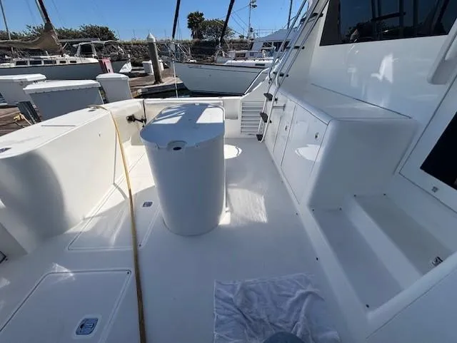 Slide: The Image of 2007 Jersey Cape 44 CNV boat deck with seating and storage, docked at marina. - 11
