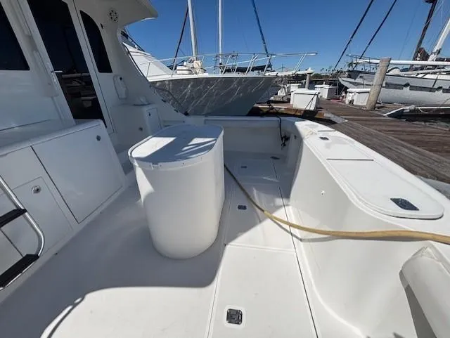 Slide: The Image of 2007 Jersey Cape 44 CNV boat deck with storage and seating at marina. - 13