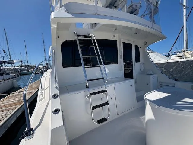Slide: The Image of 2007 Jersey Cape 44 CNV yacht with ladder and deck, docked at marina. - 15