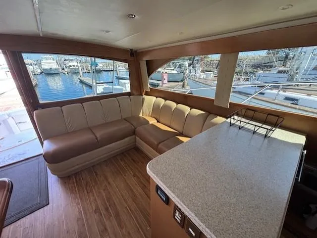Slide: The Image of Luxurious 2007 Jersey Cape 44 CNV yacht interior with spacious seating and marina view. - 18
