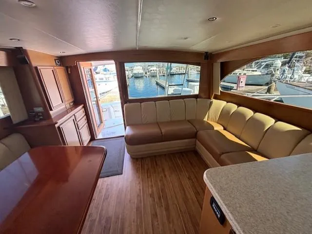 Slide: The Image of Luxurious interior of 2007 Jersey Cape 44 CNV yacht with spacious seating and marina view. - 19