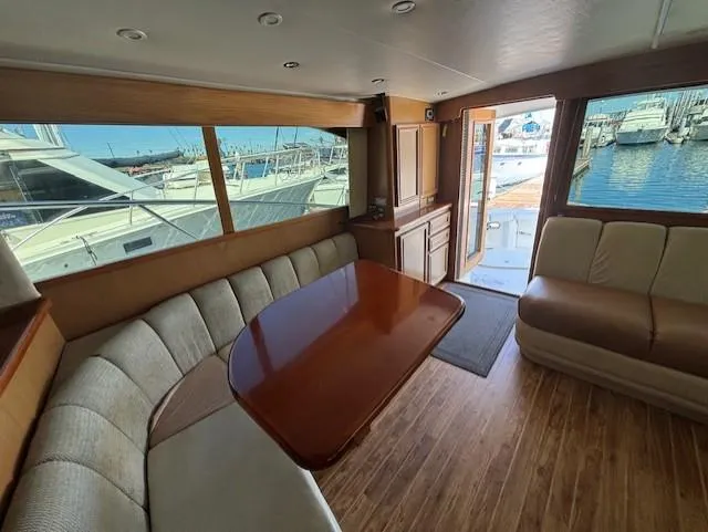 Slide: The Image of Luxurious 2007 Jersey Cape 44 CNV yacht interior with elegant seating and marina view. - 20