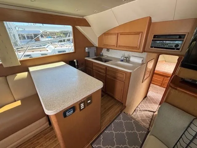 Slide: The Image of Interior of 2007 Jersey Cape 44 CNV yacht with kitchen and seating area. - 21