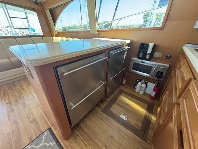 Slide: The Image of Luxurious 2007 Jersey Cape 44 CNV yacht interior with modern kitchen appliances and wood flooring. - 23