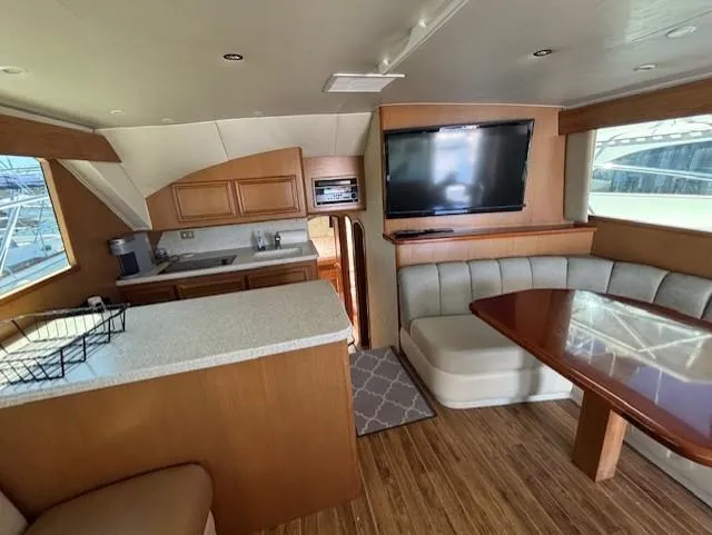 Slide: The Image of Luxurious interior of 2007 Jersey Cape 44 CNV yacht with kitchen and seating area. - 27