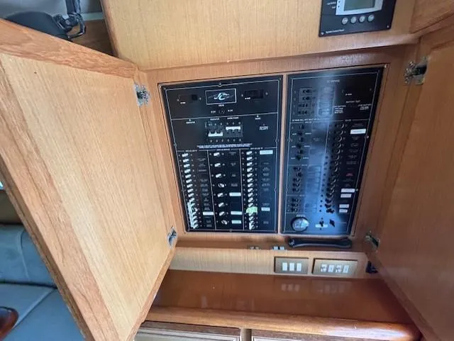 Slide: The Image of Electrical panel inside 2007 Jersey Cape 44 CNV boat, featuring switches and controls. - 29