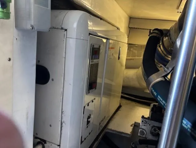 Slide: The Image of Engine room of a 2007 Jersey Cape 44 CNV boat, featuring mechanical components. - 32