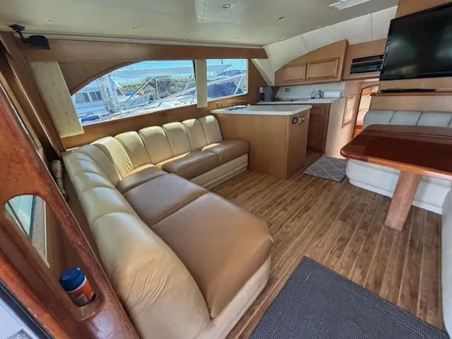 Slide: The Image of Luxurious interior of 2007 Jersey Cape 44 CNV yacht with leather seating and wooden flooring. - 34